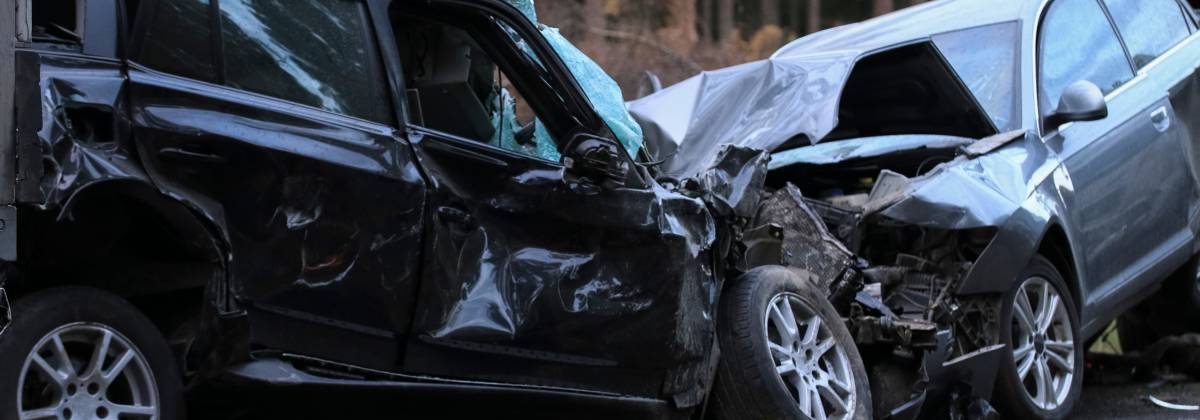 two totaled cars in head on collision